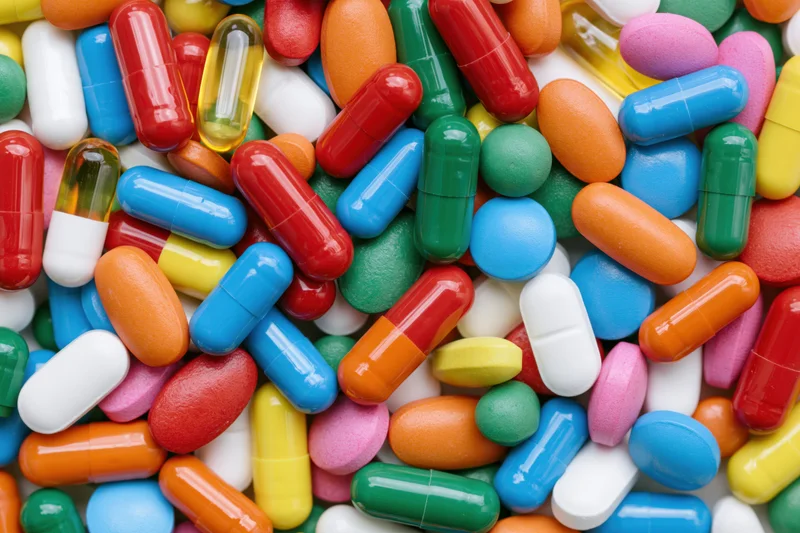 Colorful assortment of pharmaceutical pills and capsules scattered in a pile