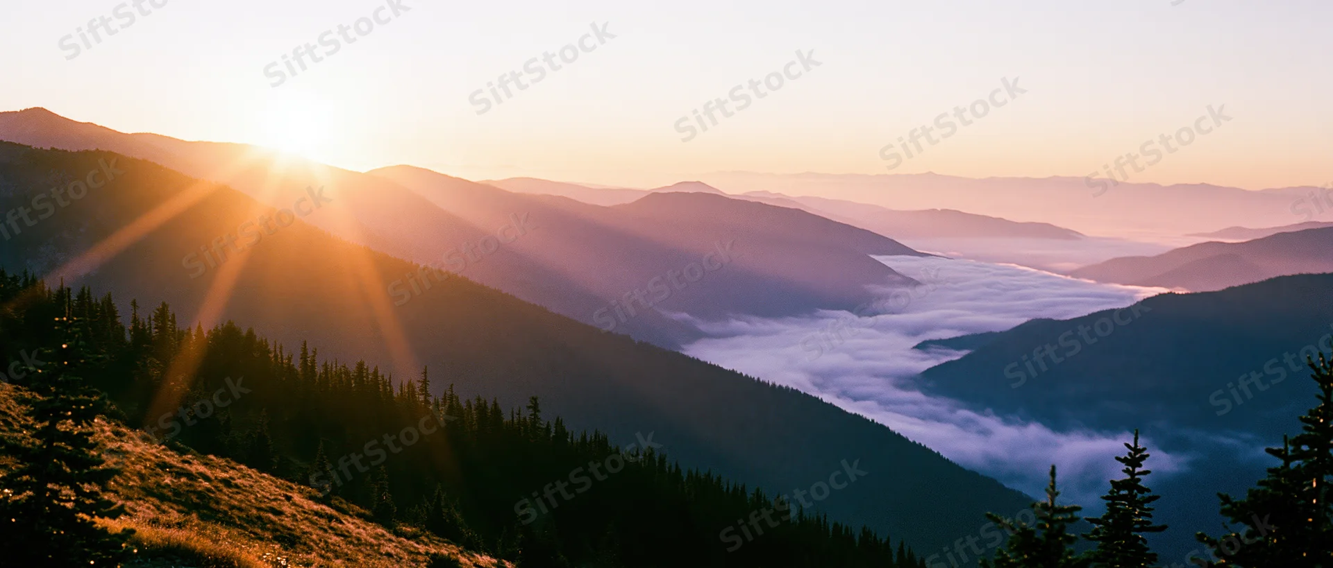 Mountain ridge at sunset with layered ridgelines receding into misty valley