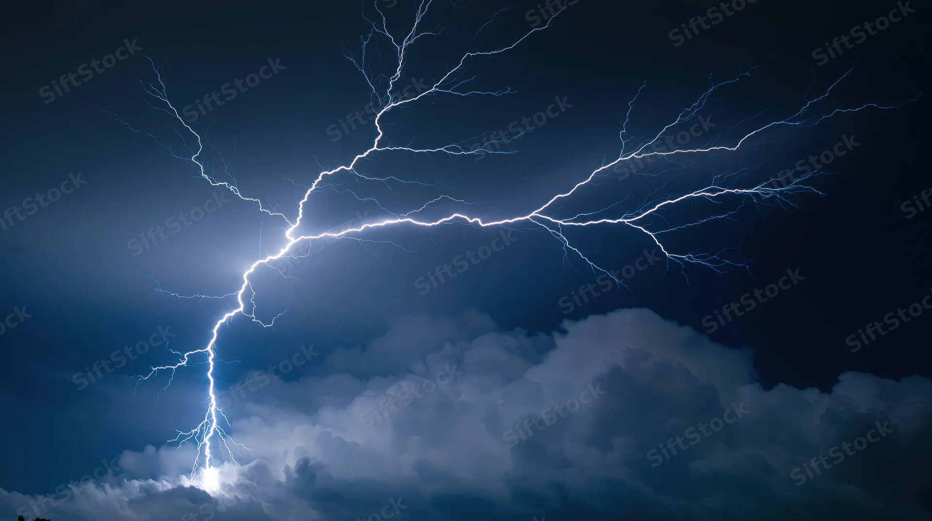 Lightning bolts branching across dark stormy night sky