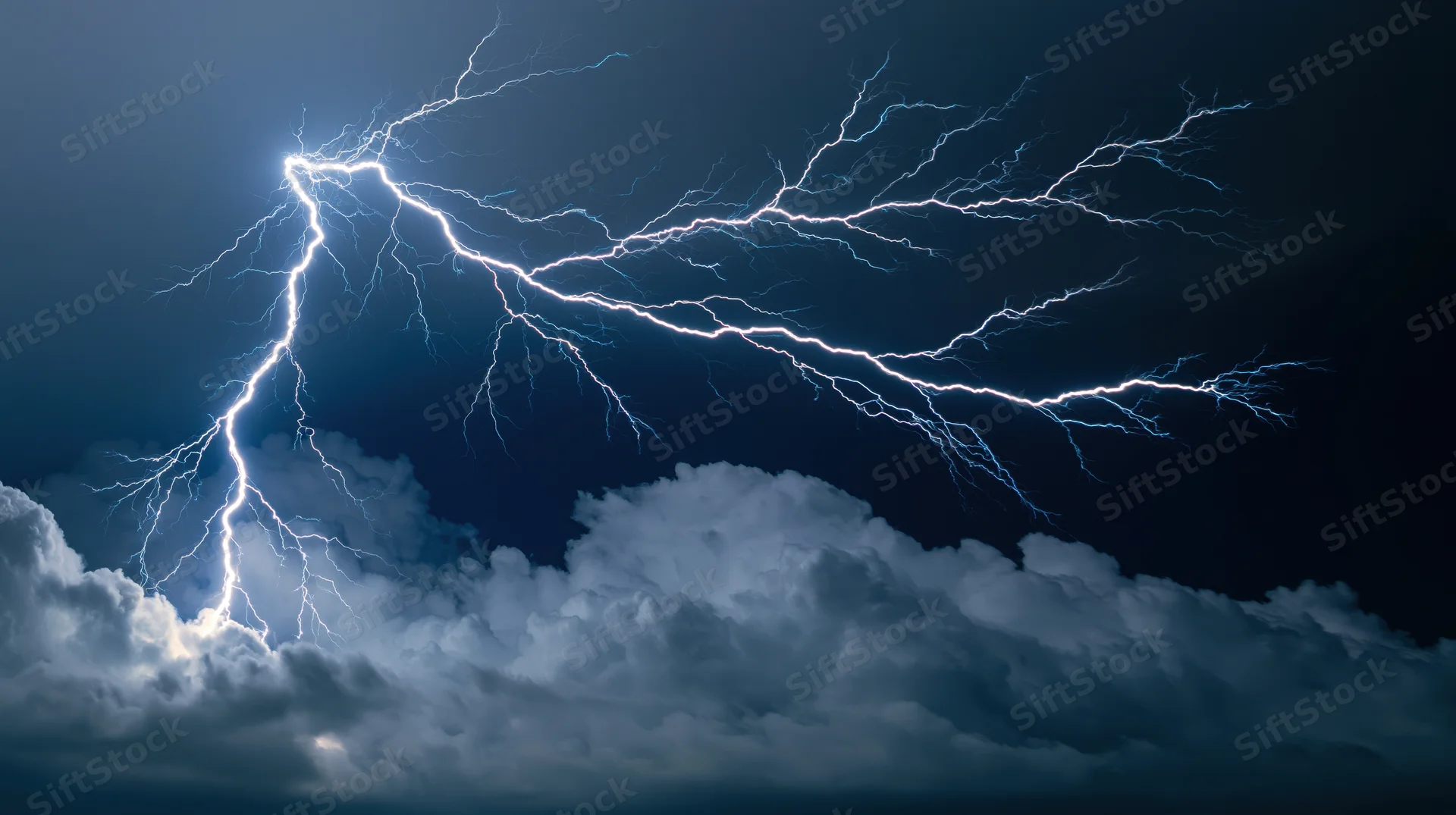Lightning bolts branching across dark stormy night sky with clouds
