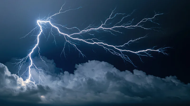 Lightning bolts branching across dark stormy night sky with clouds