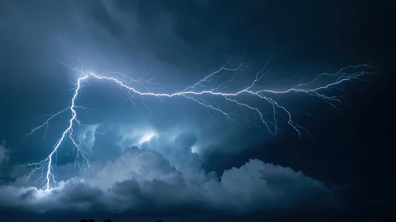 Lightning bolts branching across a dark stormy night sky