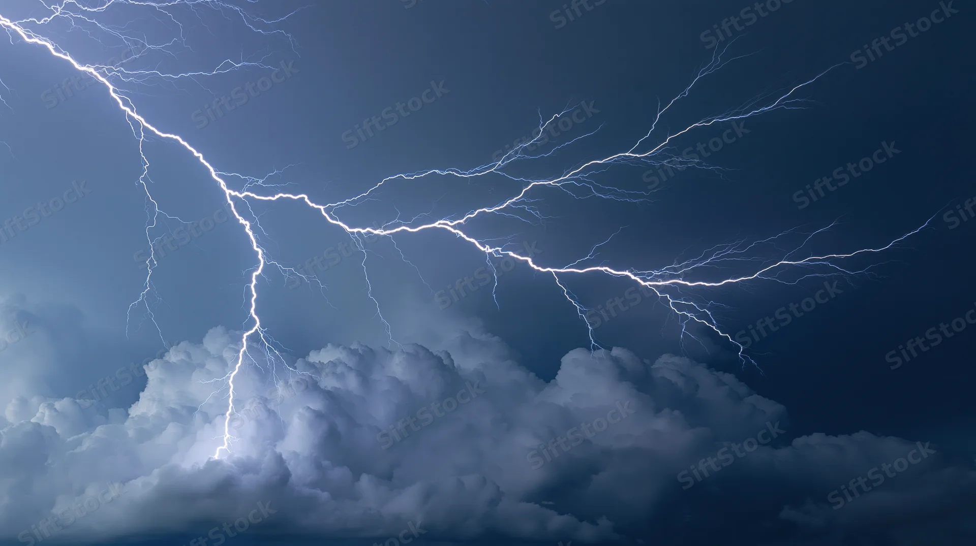 Lightning bolts branching across a dark stormy sky at night