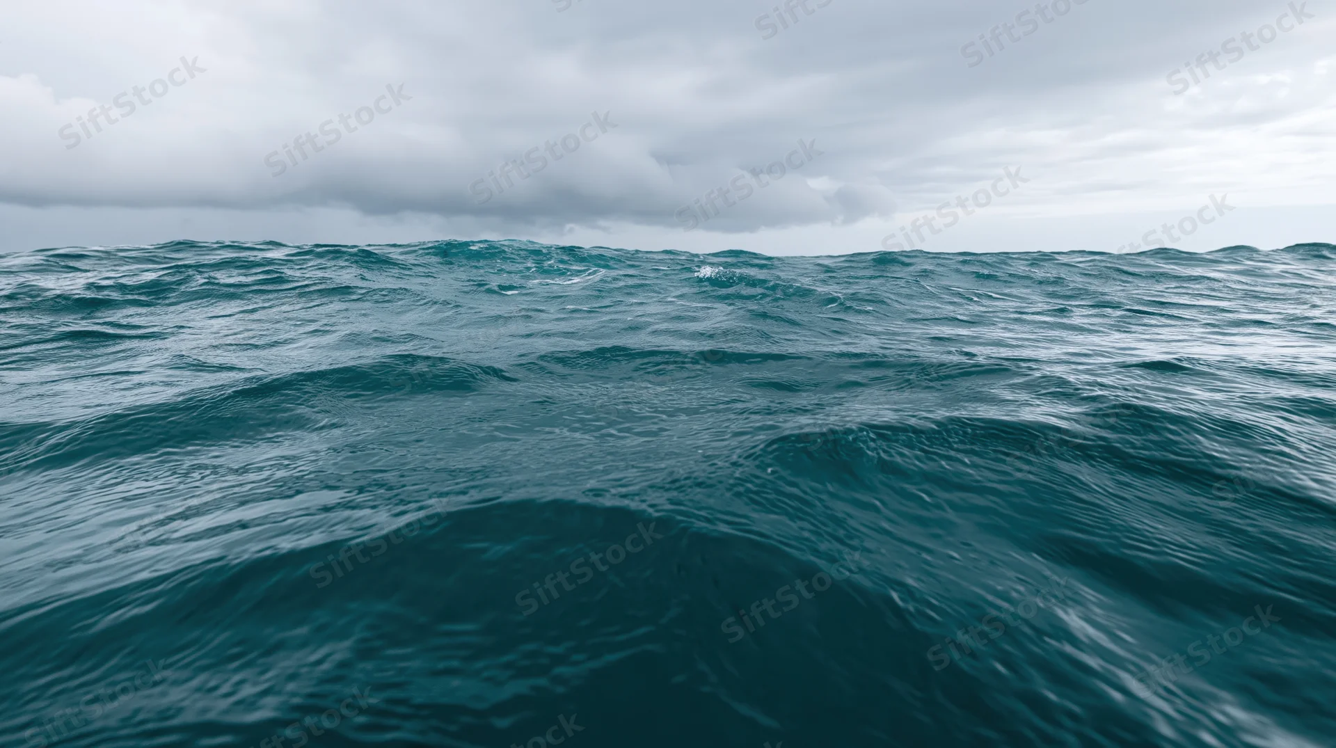 Ocean surface with choppy waves under overcast sky at water level