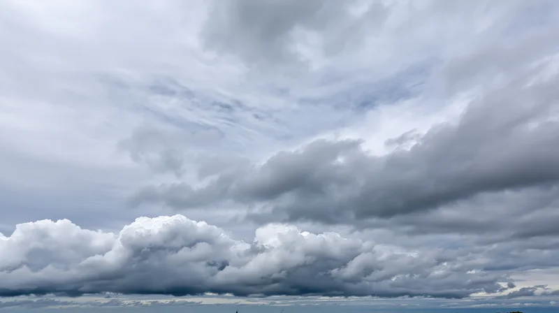 Overcast sky filled with large billowing cumulus clouds stretching across the horizon