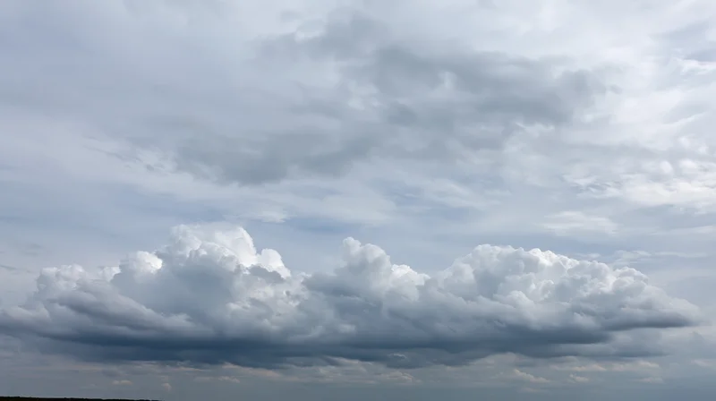 Large billowing cumulus clouds filling the sky with overcast conditions
