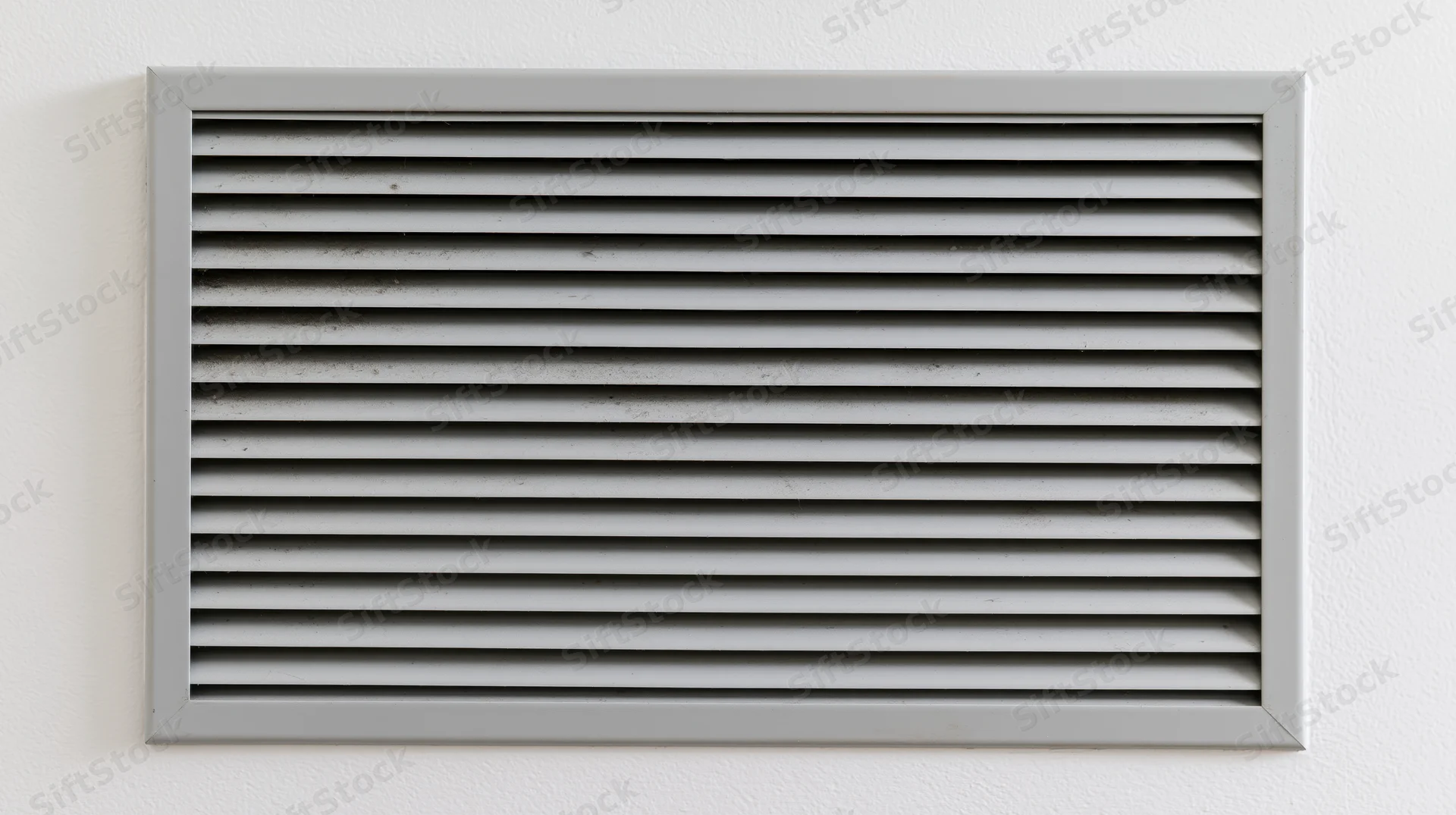 Rectangular metal vent grille with horizontal slats mounted on a white wall