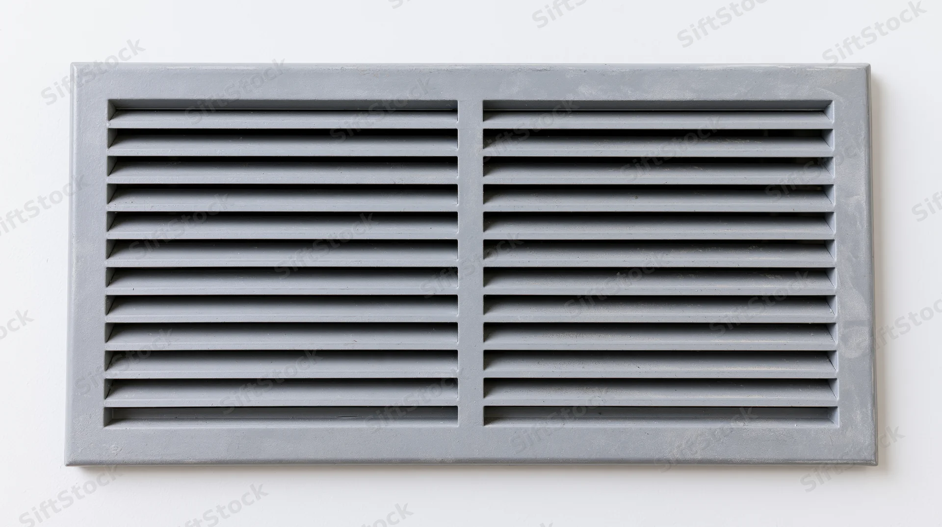 Rectangular metal vent grille with horizontal louvers mounted on a white wall