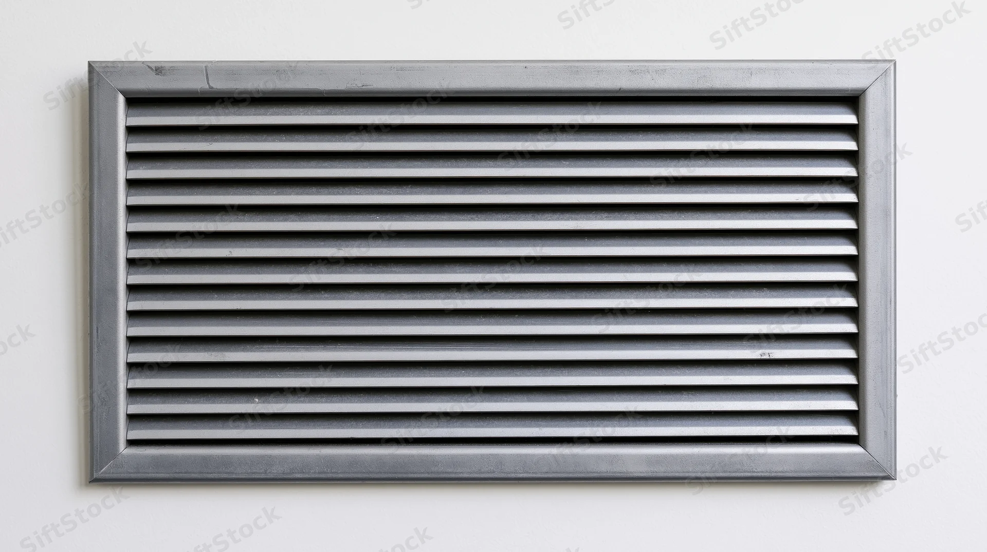 Rectangular metal vent grille with horizontal louvers mounted on a white wall