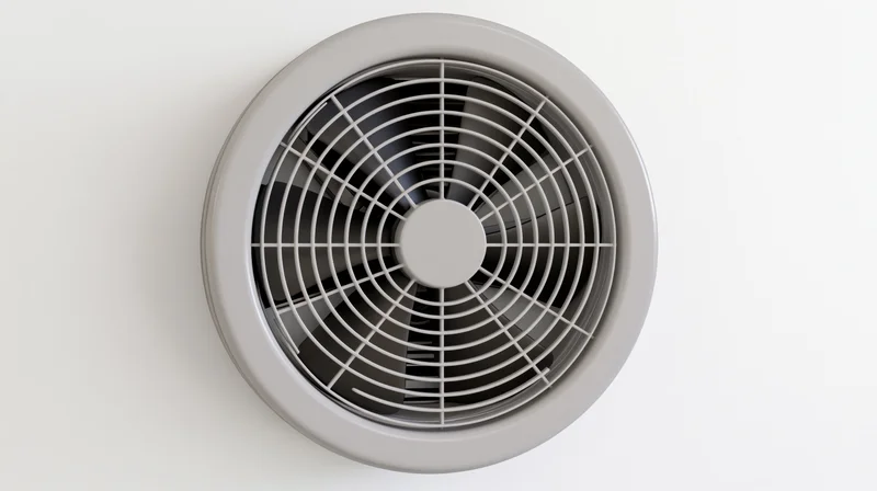 Round exhaust fan with plastic grille mounted on white ceiling