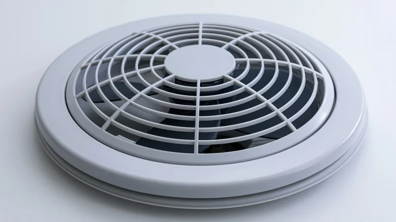 Round bathroom exhaust fan with plastic grille guard on white background