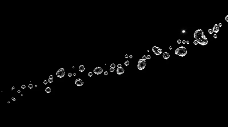 Water droplets suspended midair against a black background
