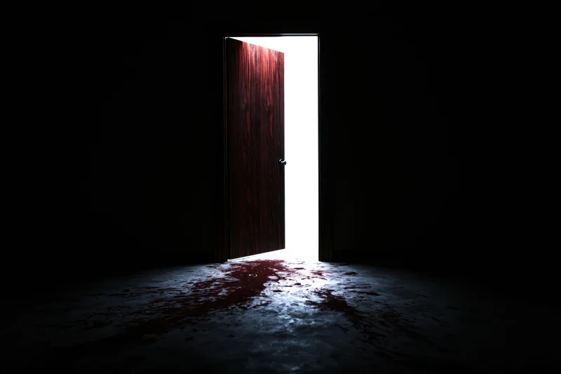 Ajar wooden door emitting bright light in dark room