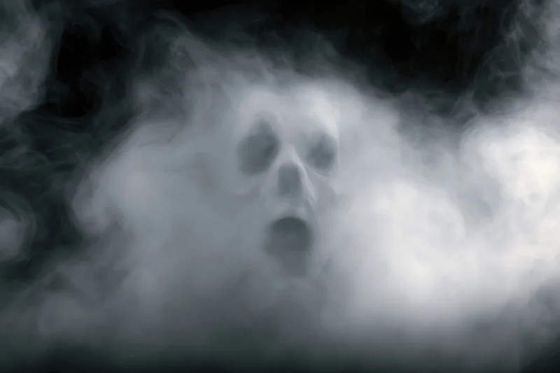 Ghostly face emerging from swirling smoke and fog