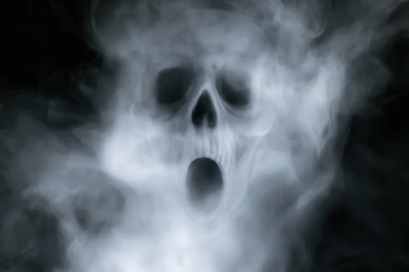 Ghostly skull screaming through swirling white smoke in dark space