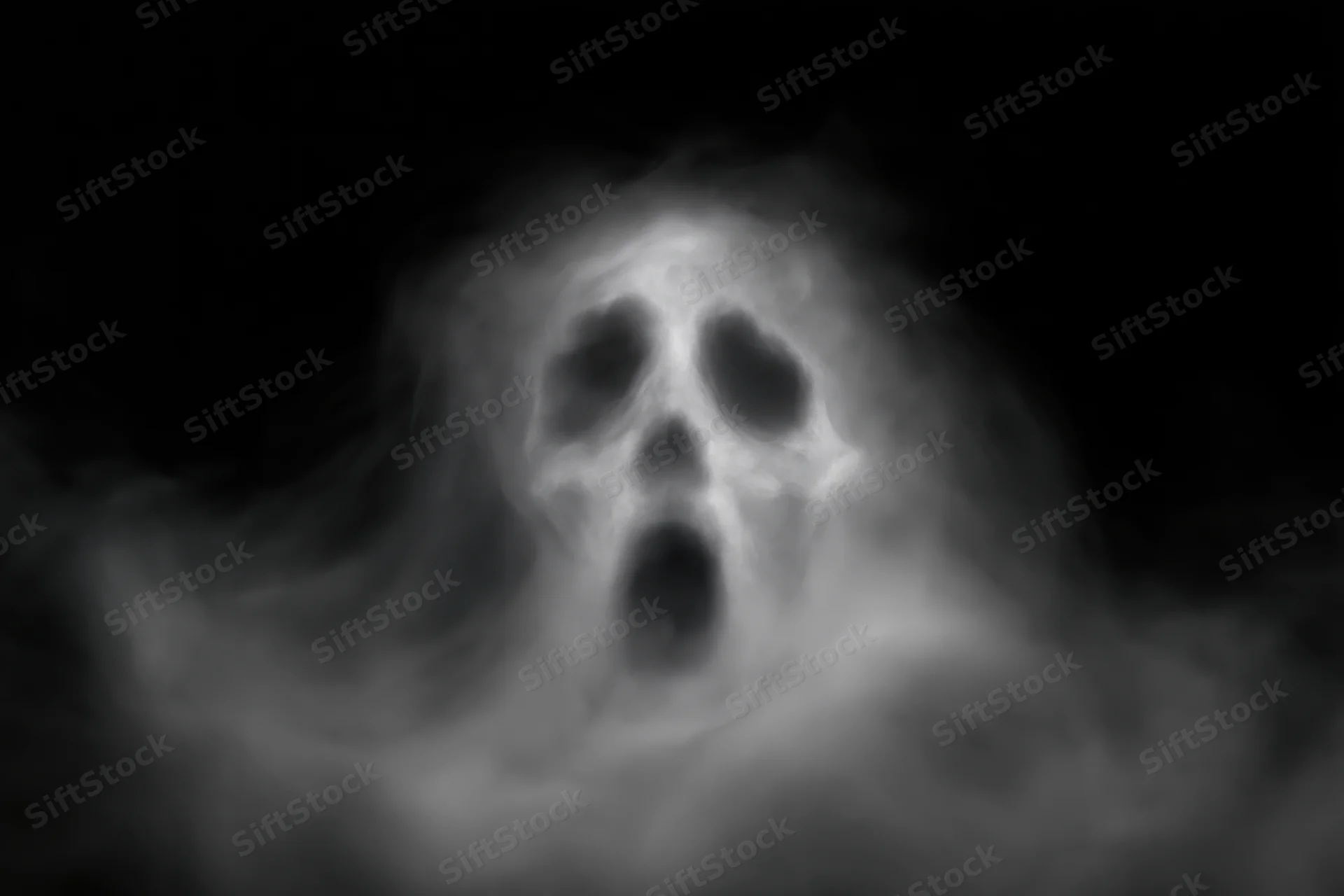 Ghostly screaming face emerging from swirling white smoke in darkness