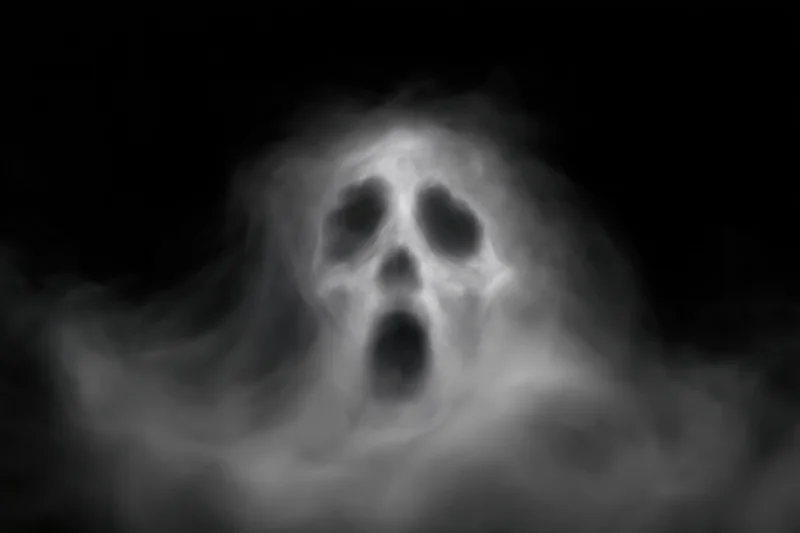 Ghostly screaming face emerging from swirling white smoke in darkness