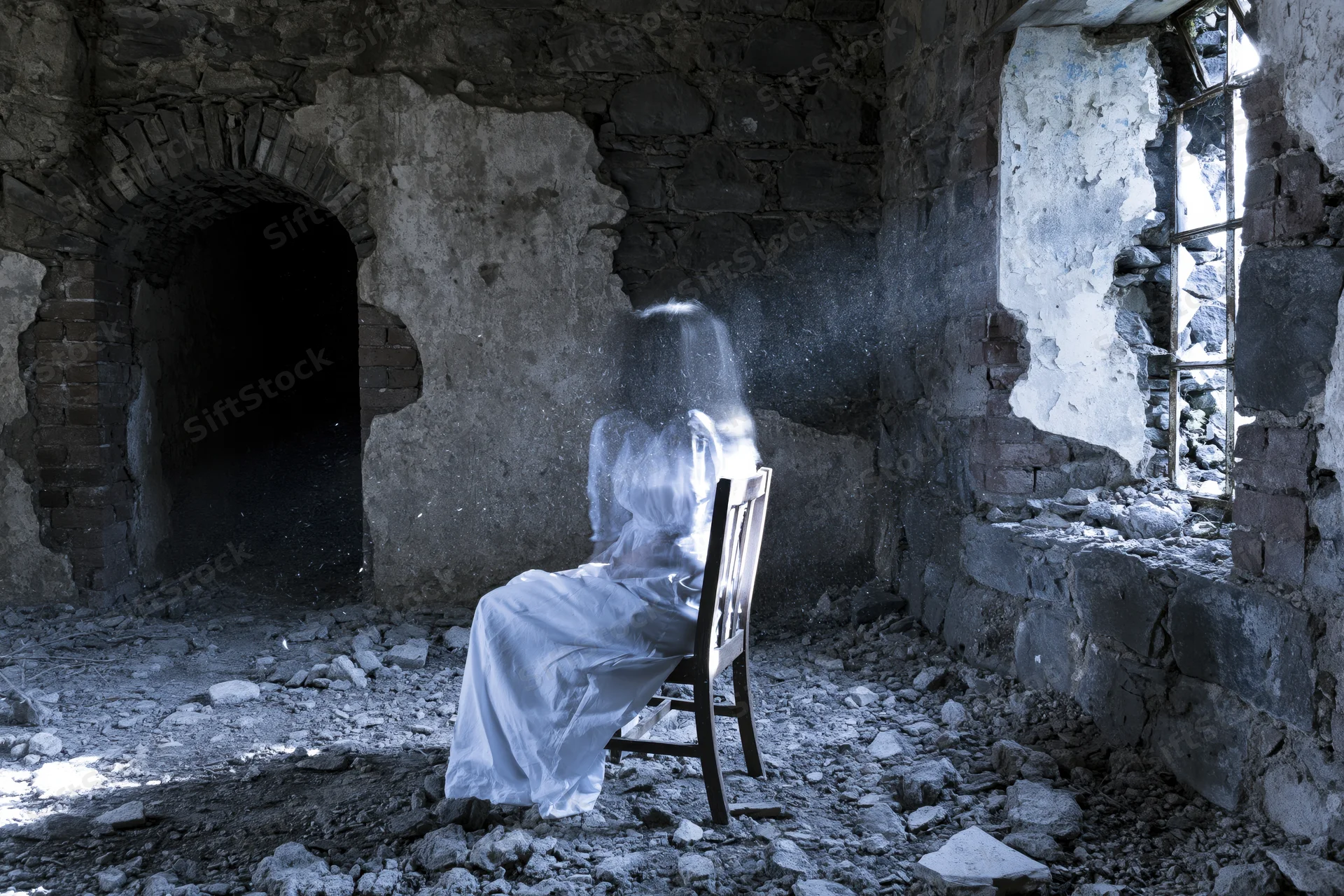 Translucent ghost figure seated on wooden chair in abandoned stone ruin