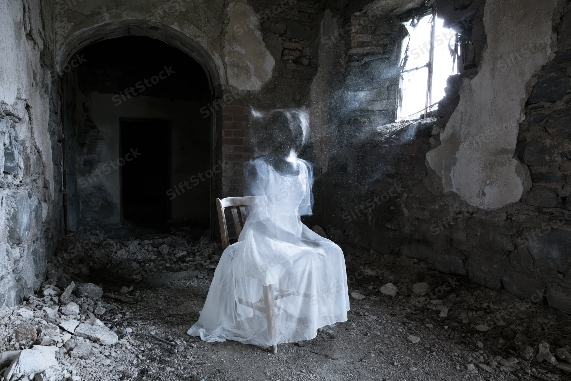 Translucent ghost figure seated on wooden chair in abandoned ruin with light streaming through broken window