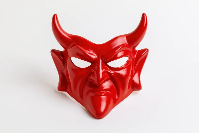 Red devil mask with curved horns and menacing expression on white background