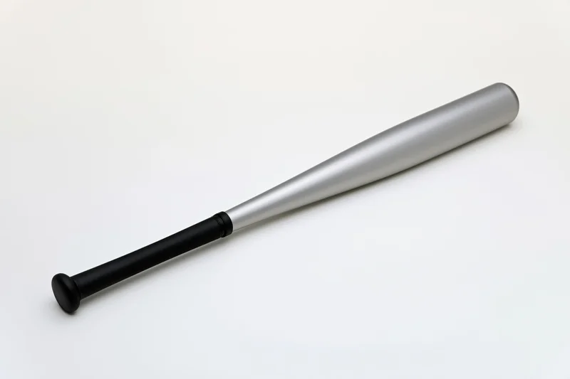 Aluminum baseball bat lying diagonally on white background