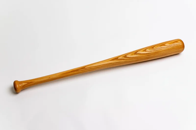 Wooden baseball bat resting diagonally on white background