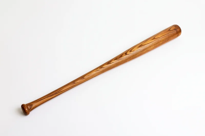 Wooden baseball bat resting diagonally on white background
