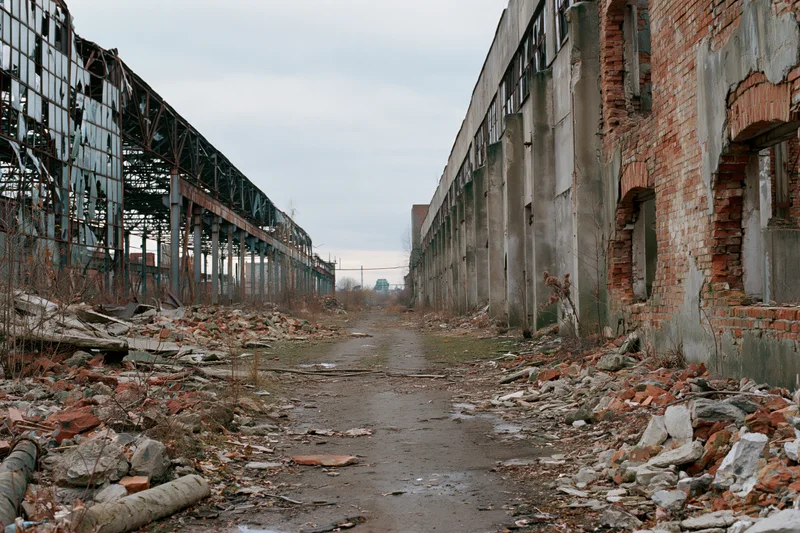 Symmetrical corridor through abandoned soviet industrial complex with crumbling brick walls and scattered rubble