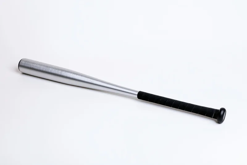 Aluminum baseball bat lying diagonally on white background