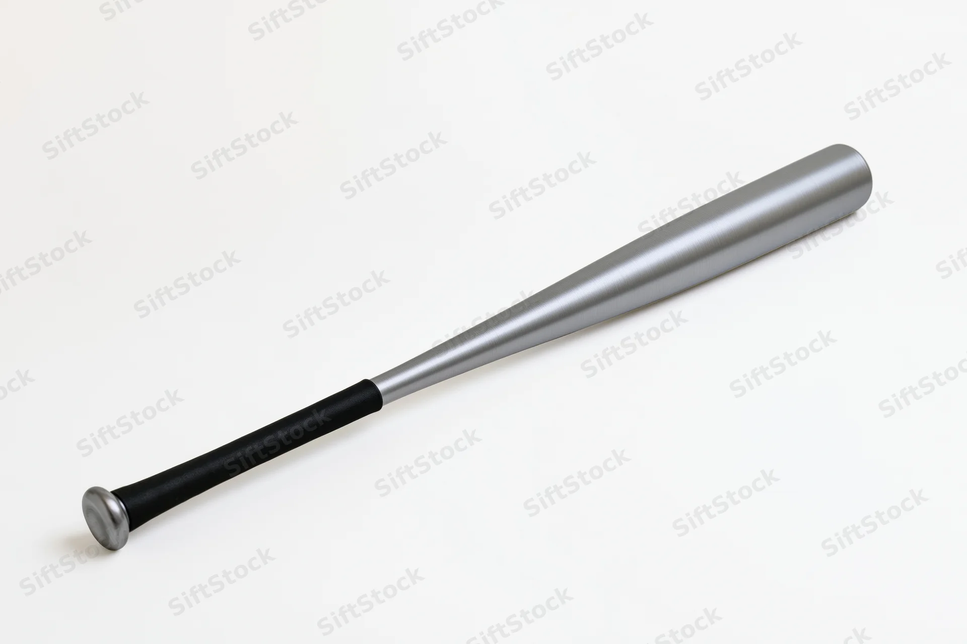 Aluminum baseball bat lying diagonally on white background