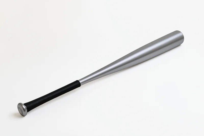 Aluminum baseball bat lying diagonally on white background