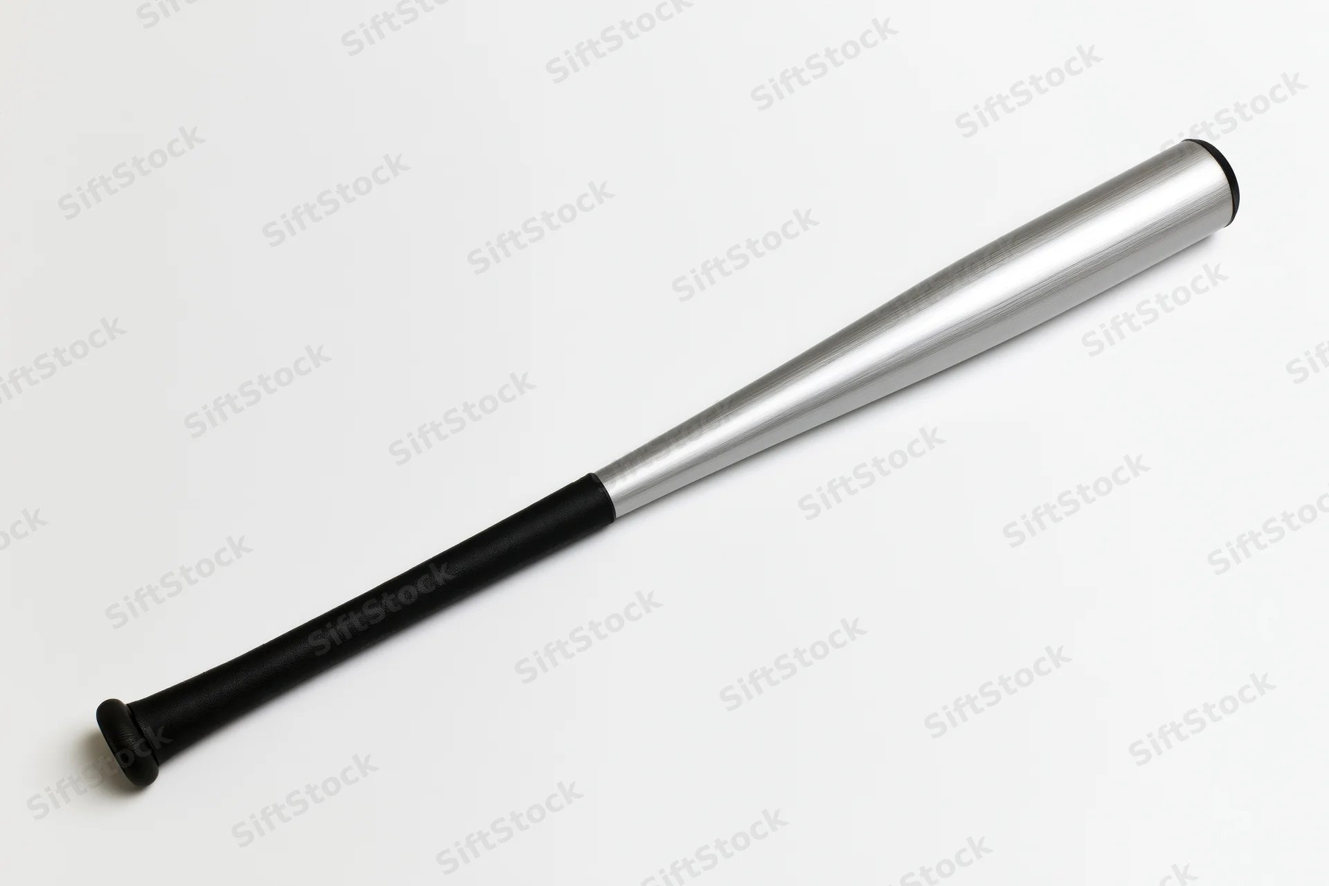 Aluminum baseball bat lying diagonally on plain white surface