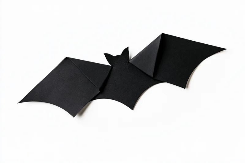 Black origami bat with folded wings isolated on white background