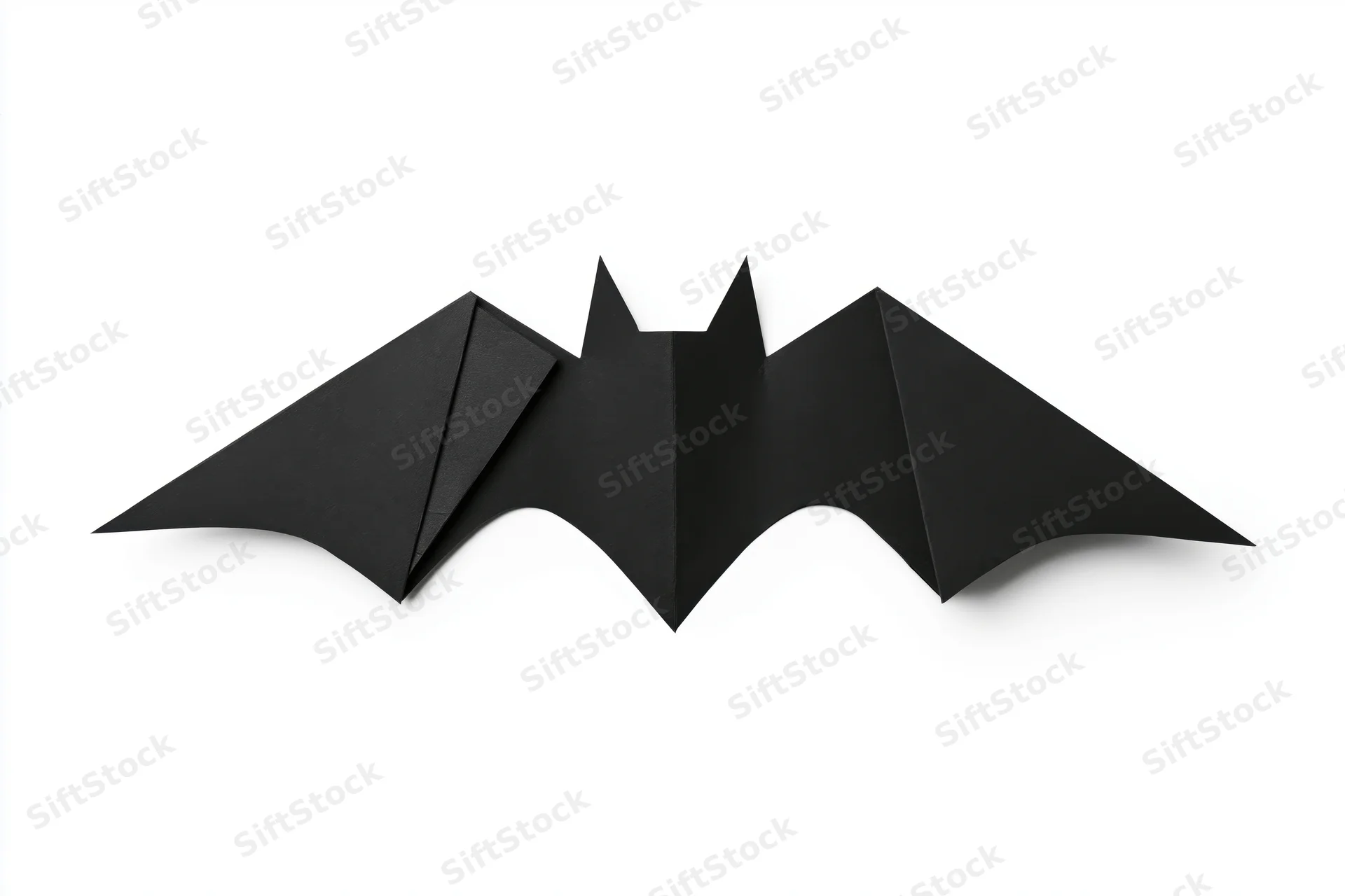 Black origami bat with folded wings isolated on white background
