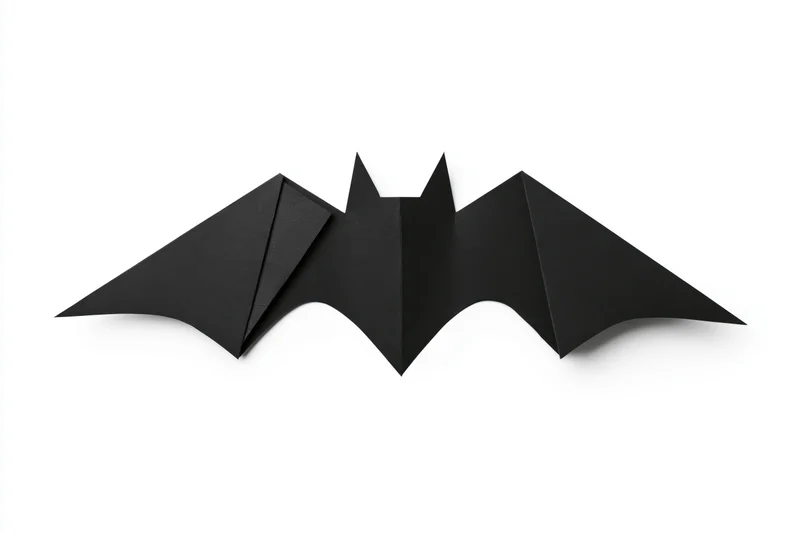 Black origami bat with folded wings isolated on white background