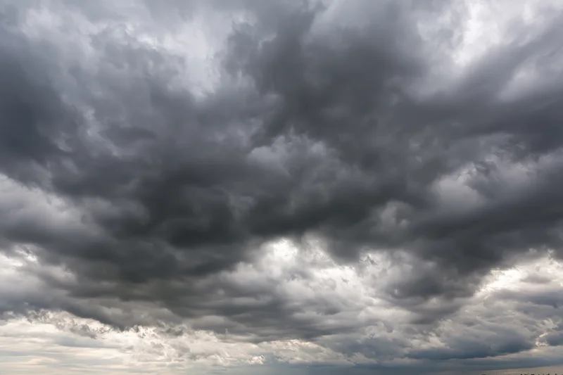 Dark storm clouds filling the sky with heavy cumulonimbus formations