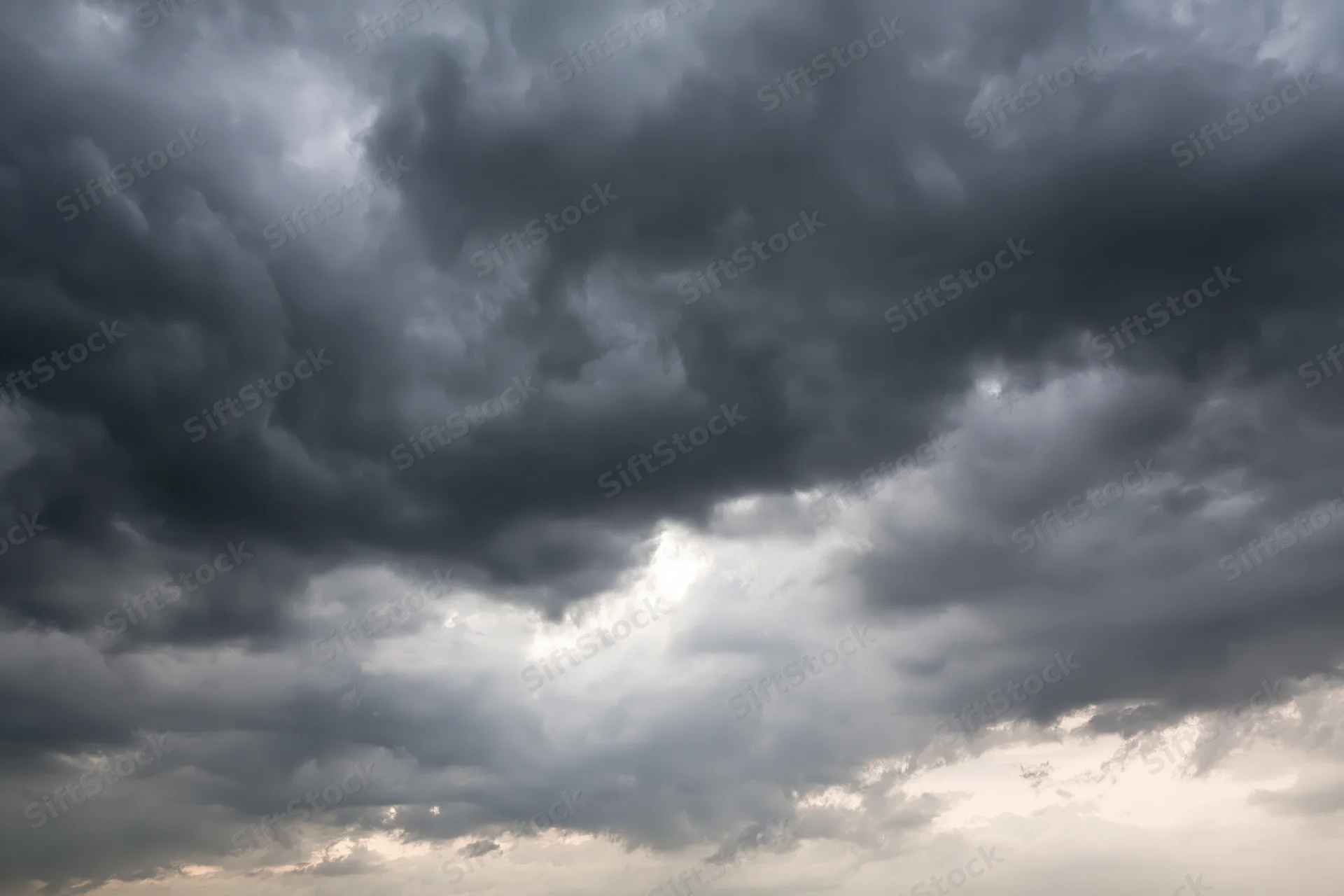 Dark storm clouds filling the sky with heavy cumulonimbus formations