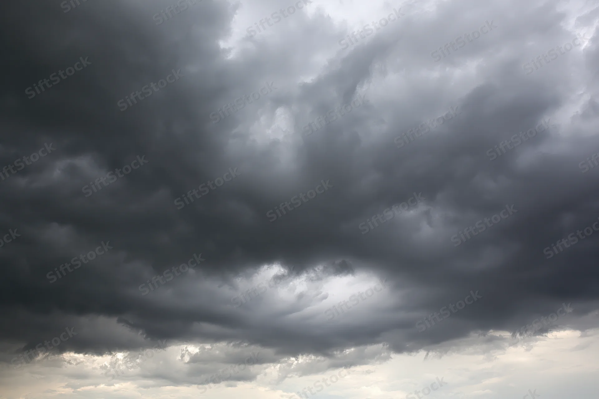 Dark storm clouds filling the sky with heavy cumulonimbus formations