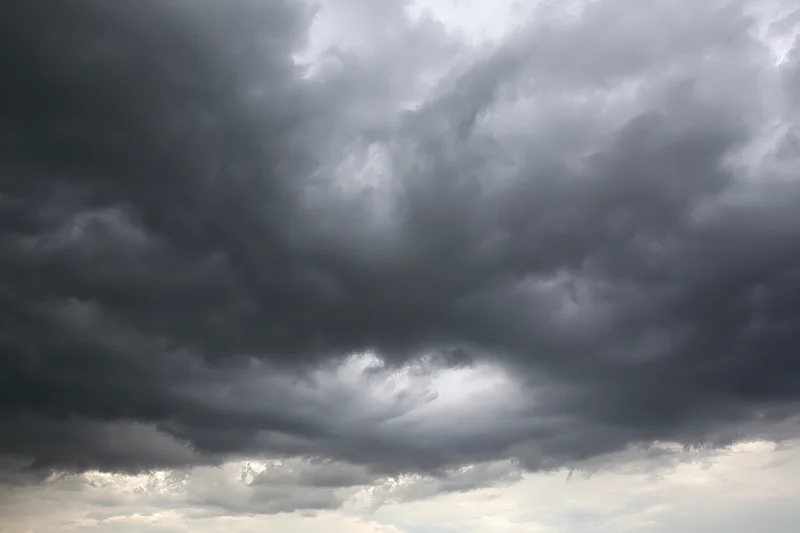 Dark storm clouds filling the sky with heavy cumulonimbus formations
