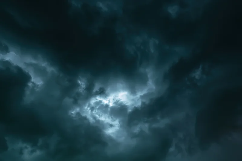 Dark stormy sky filled with heavy turbulent clouds at night