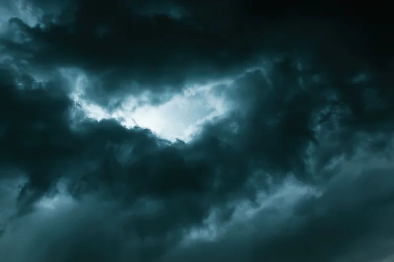 Dark stormy sky filled with heavy turbulent clouds at night