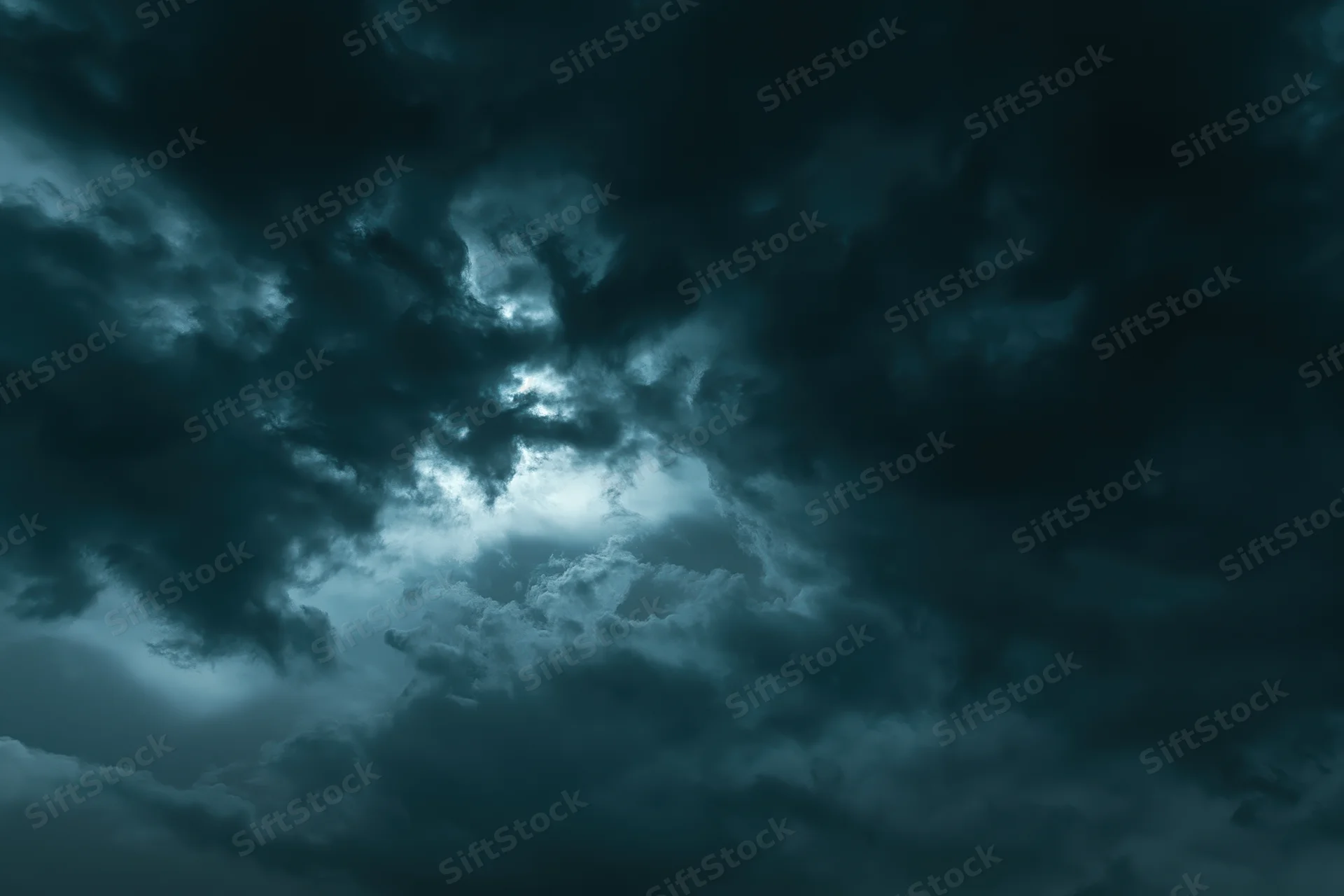 Dark stormy sky filled with heavy turbulent clouds at night