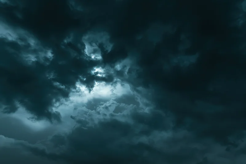 Dark stormy sky filled with heavy turbulent clouds at night