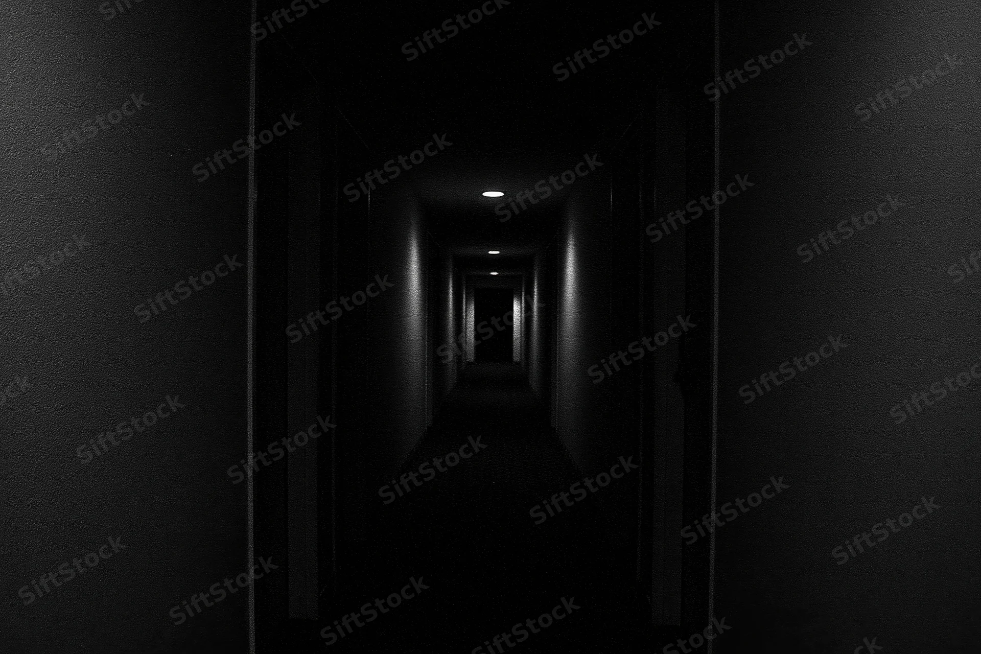 Dark hotel corridor receding into shadow with recessed ceiling lights and textured walls