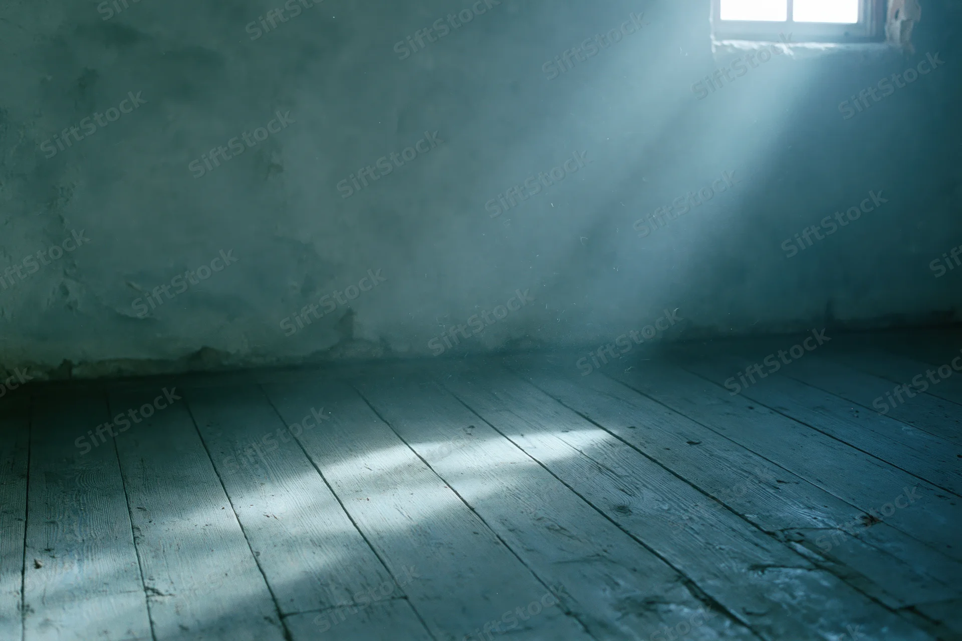 Empty room with weathered wooden floorboards and rough concrete walls, light streaming through a small window