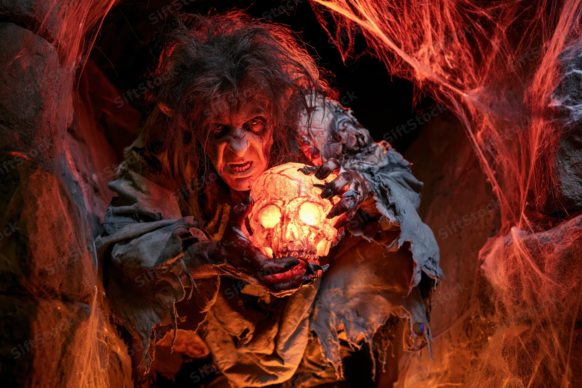 Monster with glowing skull in a cobweb-filled cave