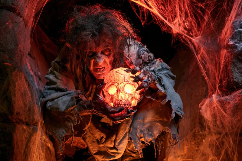 Monster with glowing skull in a cobweb-filled cave