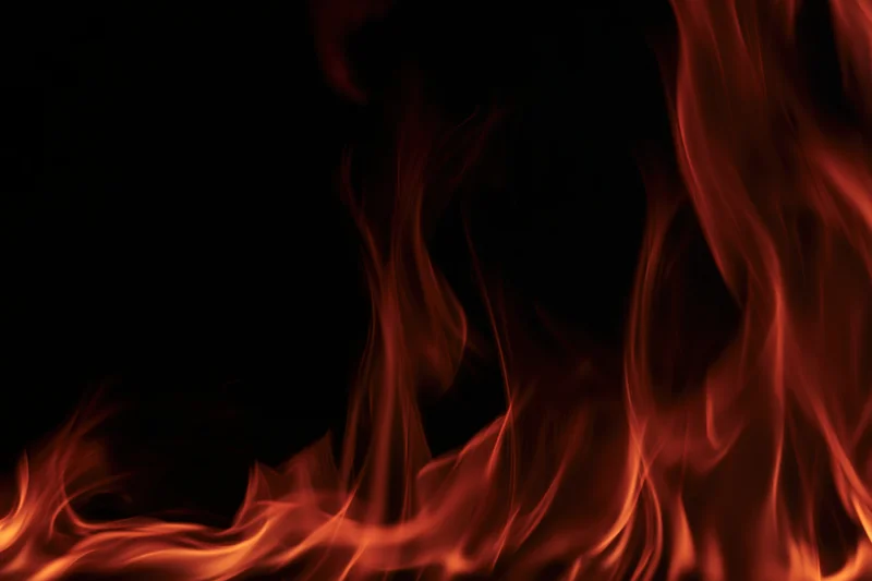 Flames curving along the bottom edge against a dark background