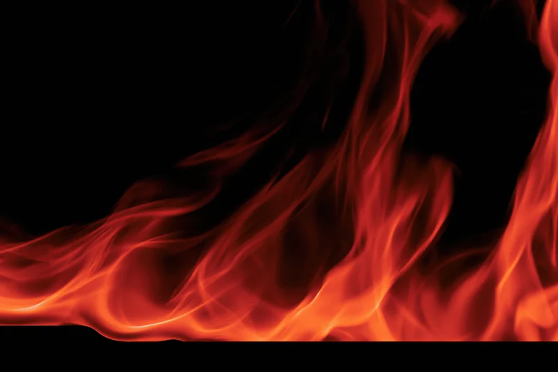 Red and orange flames curving along the bottom edge of the frame against a black background