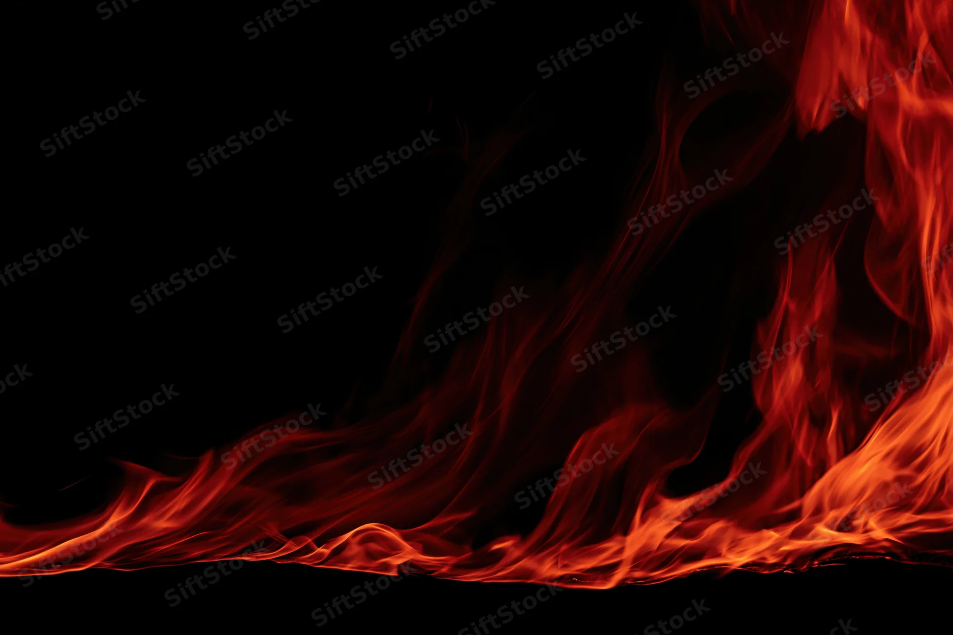 Red and orange flames curving along the bottom edge against black background